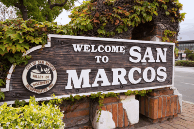 A sign reading "Welcome to San Marcos." Many homeowners are building ADUs on their properties in the San Diego area, including San Marcos, California.